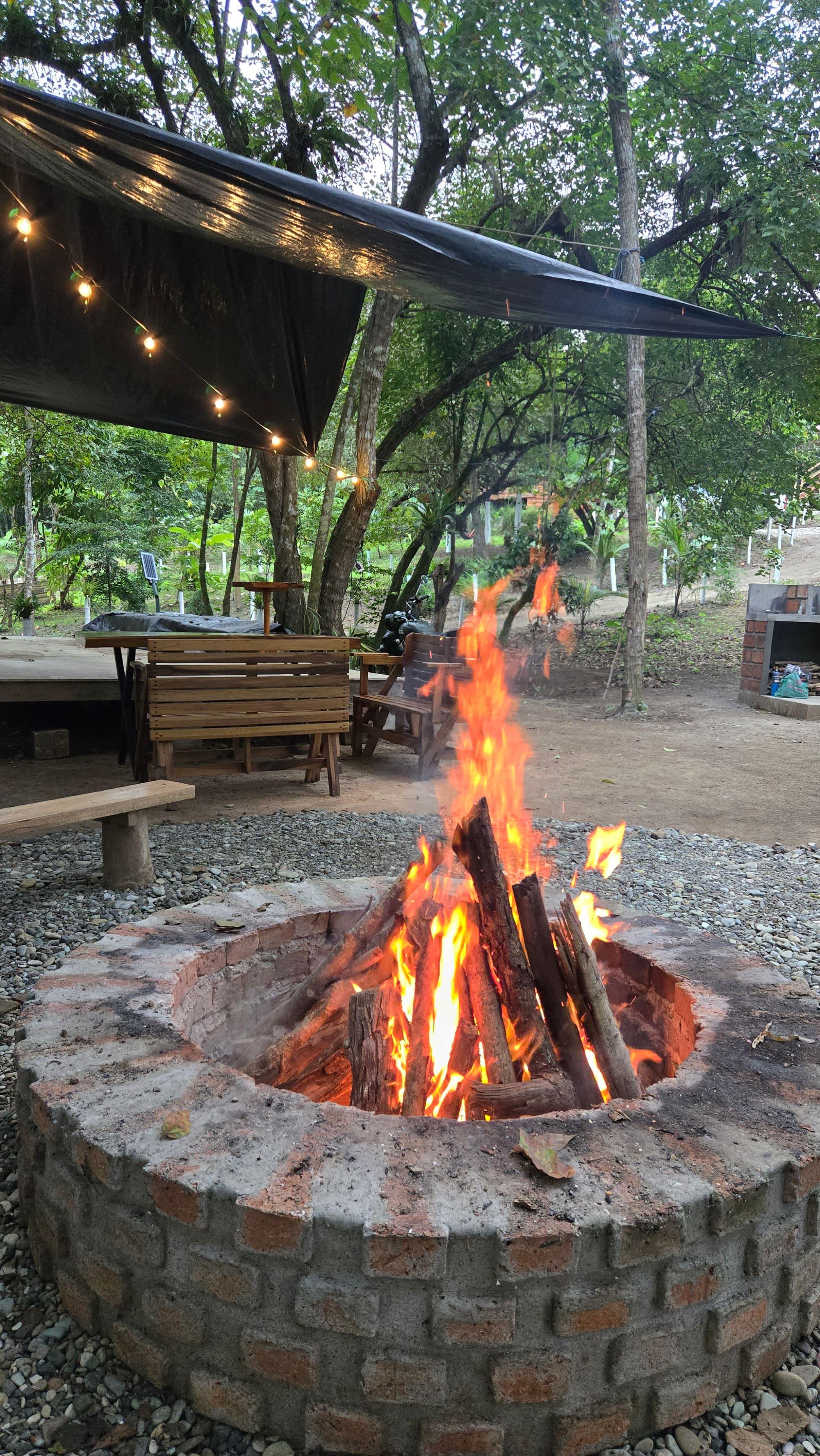 A fire burning in the farm's fire circle at dusk