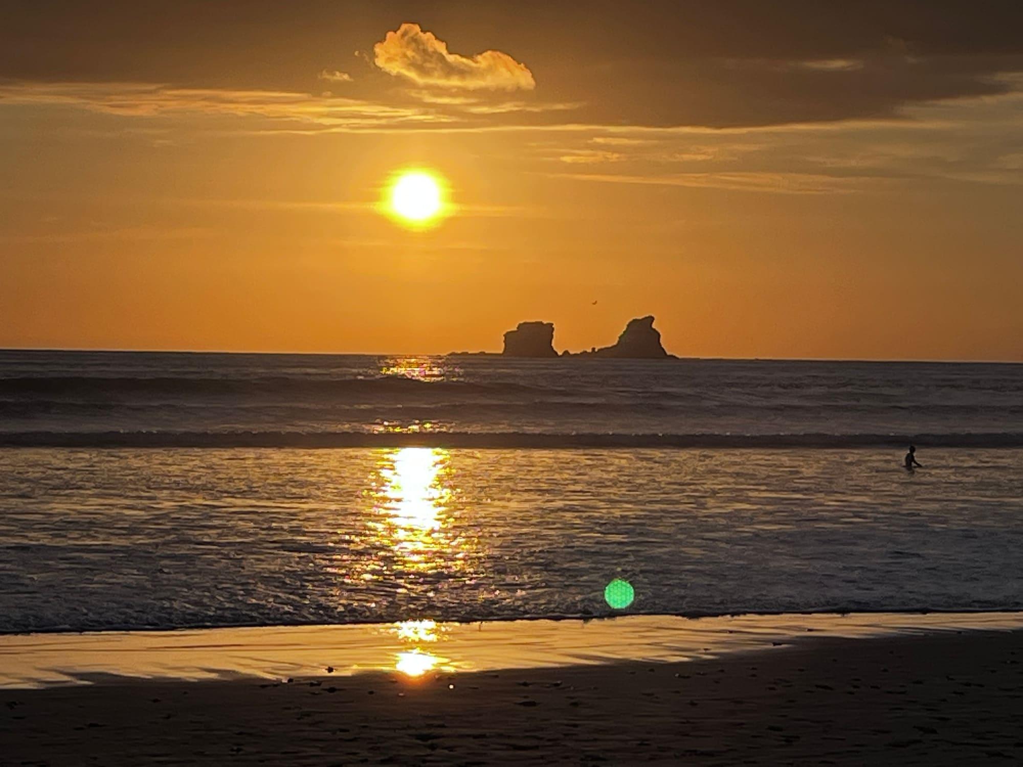The sun setting over the islet off Ayampe beach