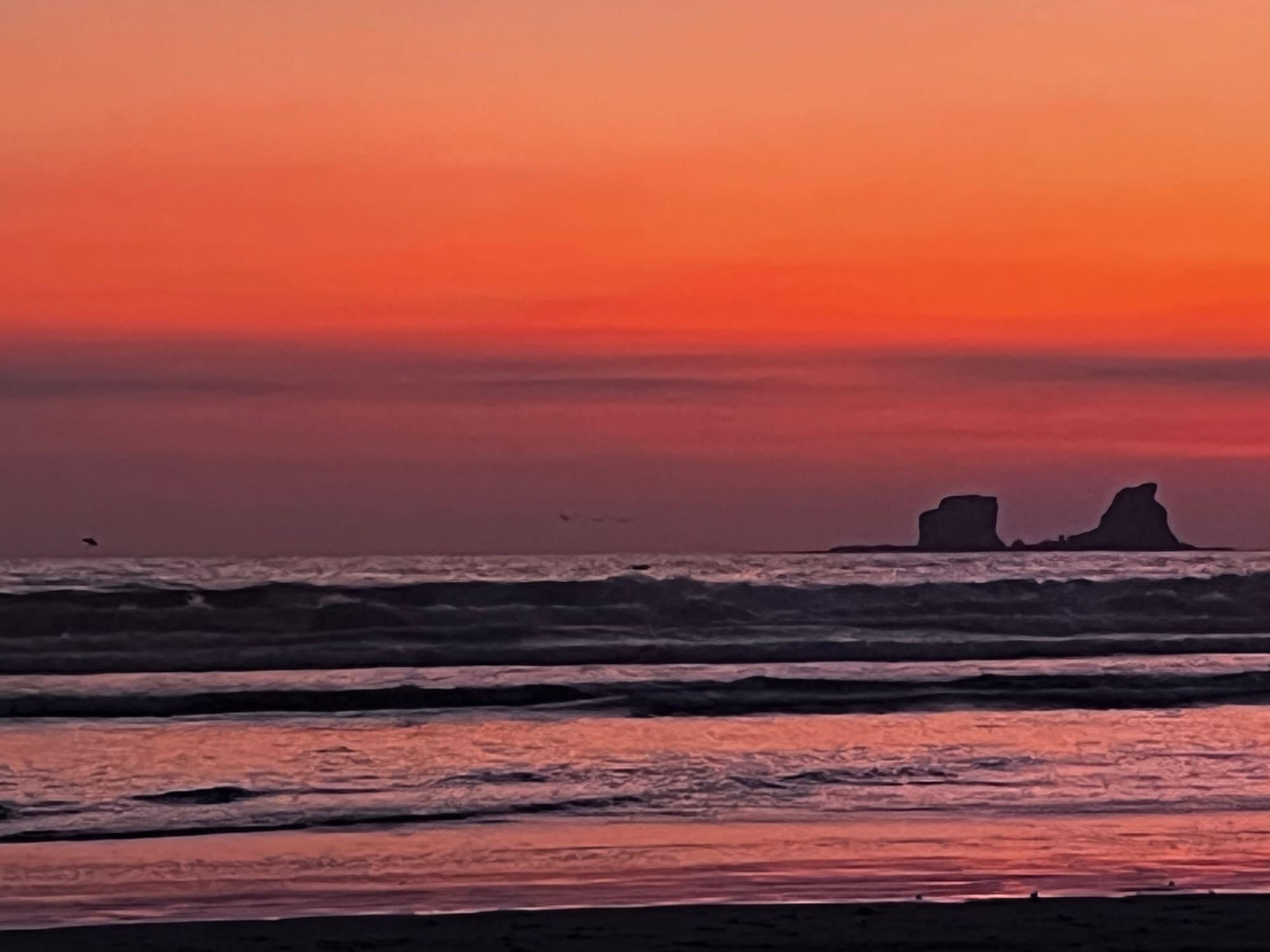 The Pacific Ocean at dusk off Ayampe, with the islet on the horizon